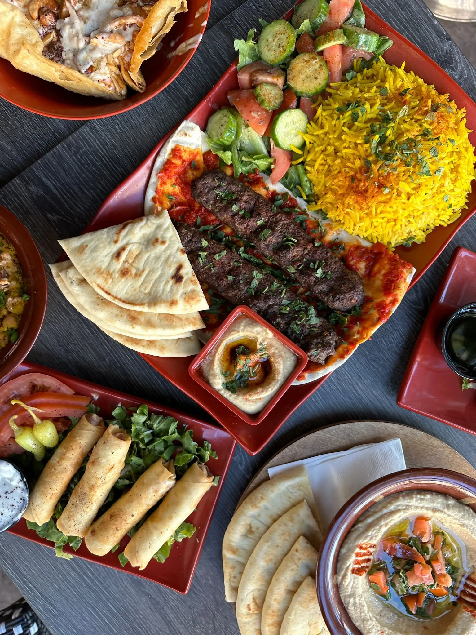 Mixed grill plate with kafta, yellow rice, pita, hummus and spring rolls